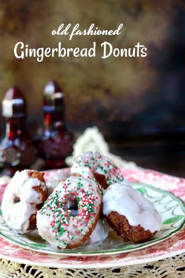 Lemon glazed gingerbread donuts piled on a green and white plate. Title image.