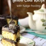 Title image for yellow cake recipe shows a slice of yellow layer cake with fudge filling and frosting on a plate. a sliver fork is thrust into the cake. An antique teapot is in the background.