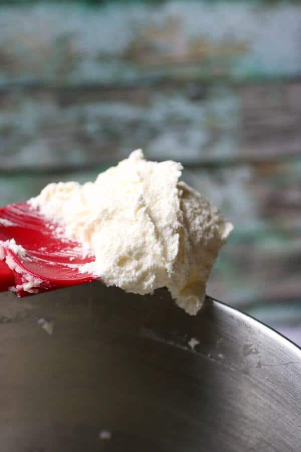 creamed butter for yellow cake recipe on a red spatula