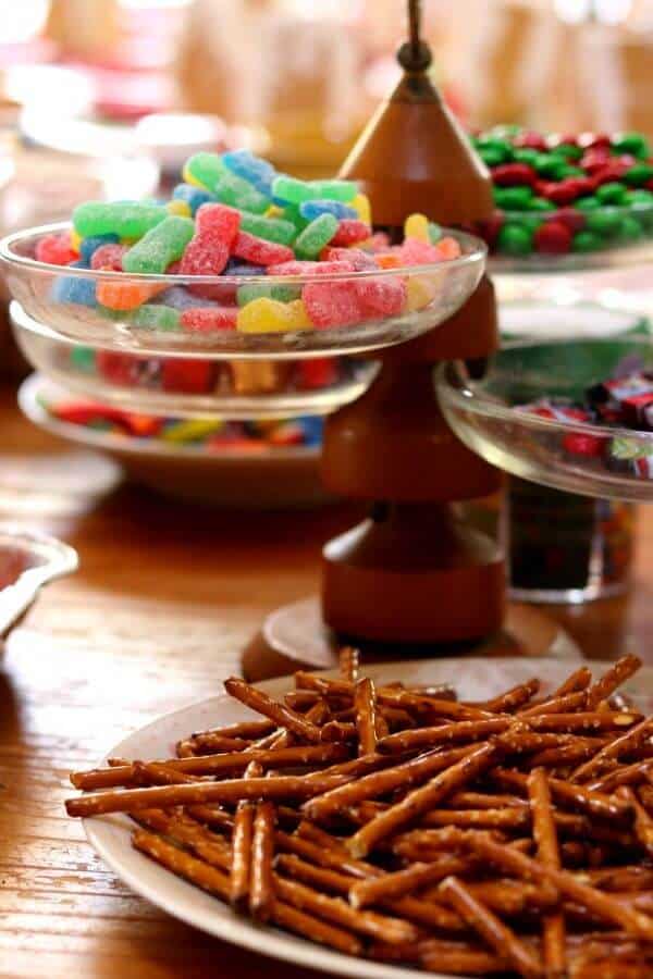 pretzels and candy on the table for the gingerbread house party