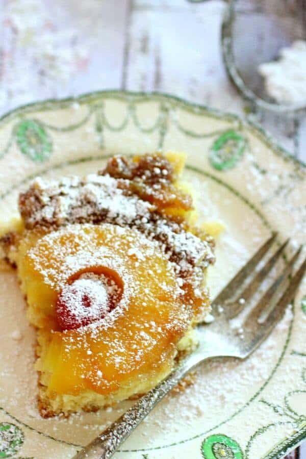 This easy pineapple upside down cake from scratch is updated from a vintage recipe. #restlesschipotle #pineapple #recipe #best #homemade #fromscratch #13x9 Delicios pineapple upside down cake slice next to a silver fork.