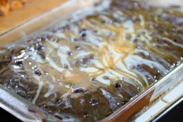Chocolate and caramel syrups plus sweetened condensed milk soaks into the holy cow cake