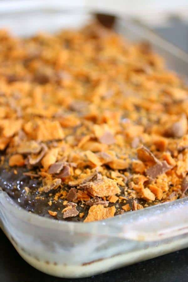 Sprinkle the chopped Butterfingers bars over the top of the holy cow cake
