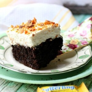 A square of chocolate holy cow cake with whipped cream topping and chopped Butterfingers candy on top. Image for recipe box