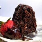 a slice of chocolate cake on a cake plate