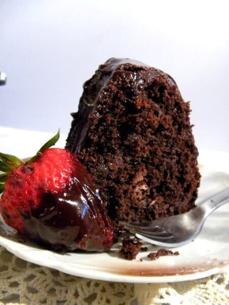 a slice of chocolate cake on a cake plate