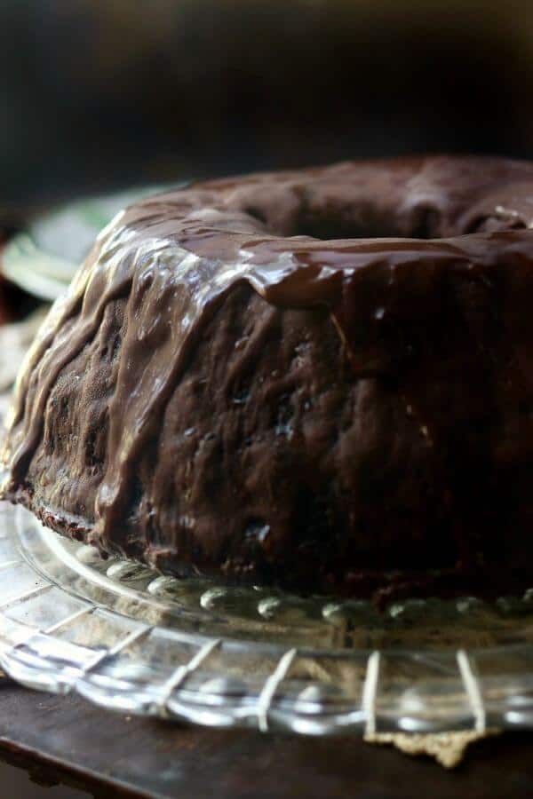 Whole black lager chocolate cake with chocolate ganache dripping down the sides