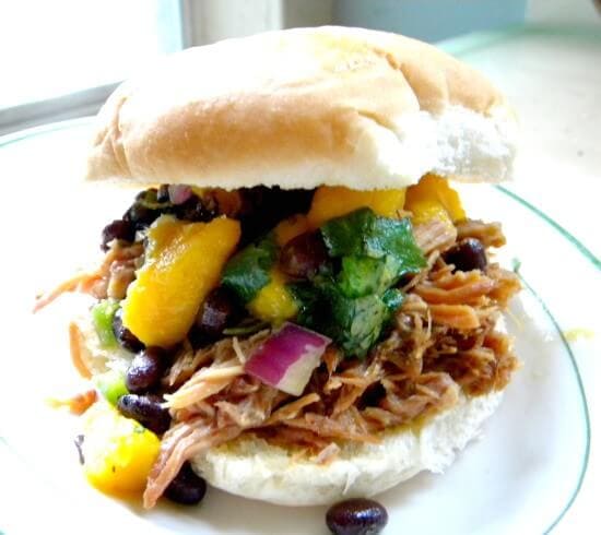 Pulled pork sandwich with mango salsa on top.