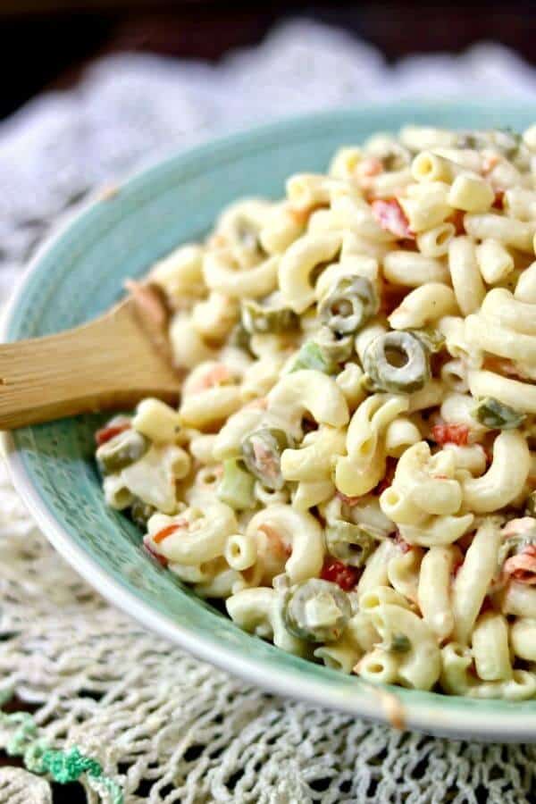 Closeup of a bowl of old fashioned macaroni salad on lacy table.