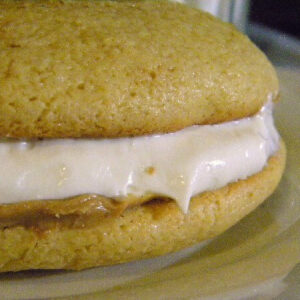 A close-up of a peanut butter whoopie pie with marshmallow filling.