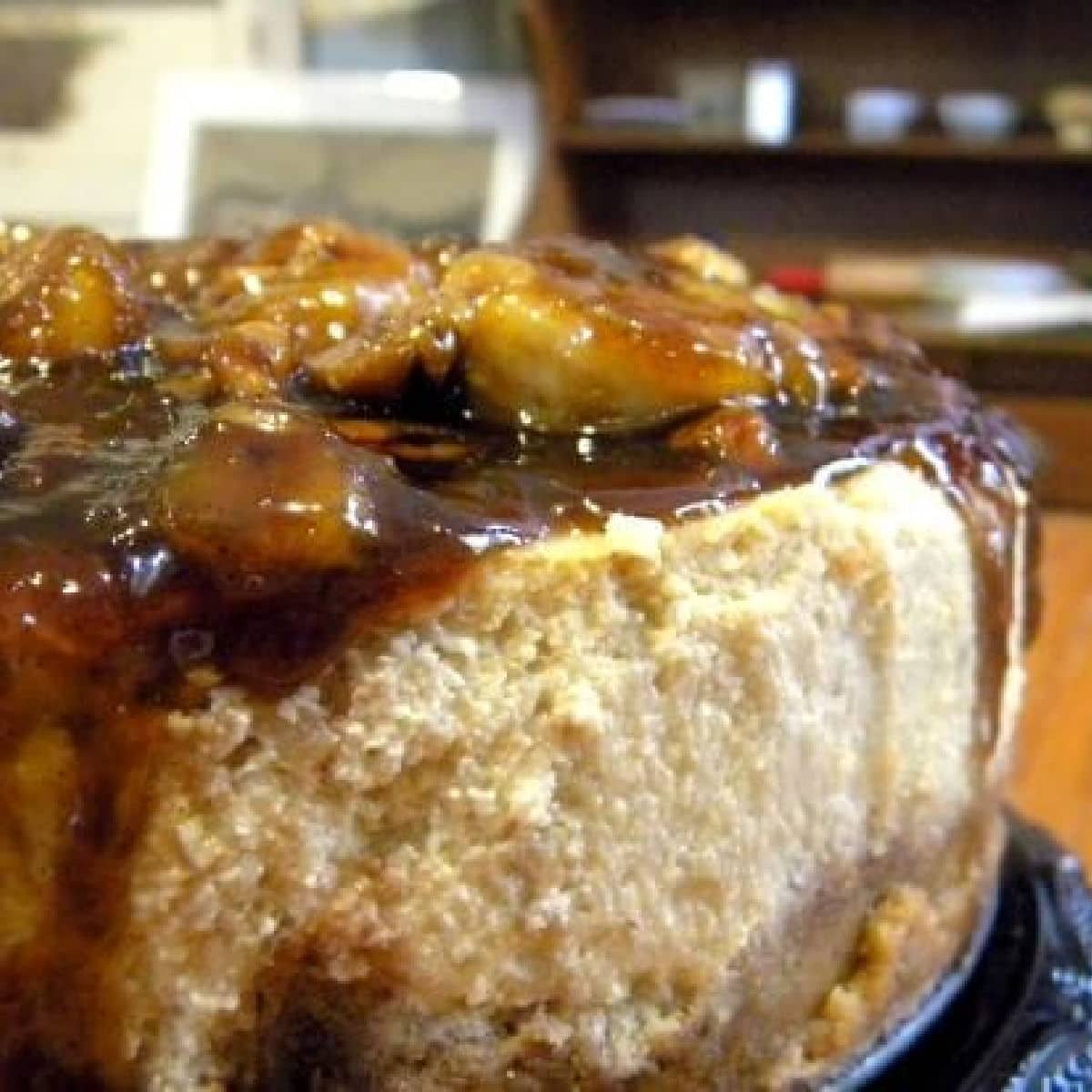 A closeup of a cheesecake with banana and brown sugar topping.