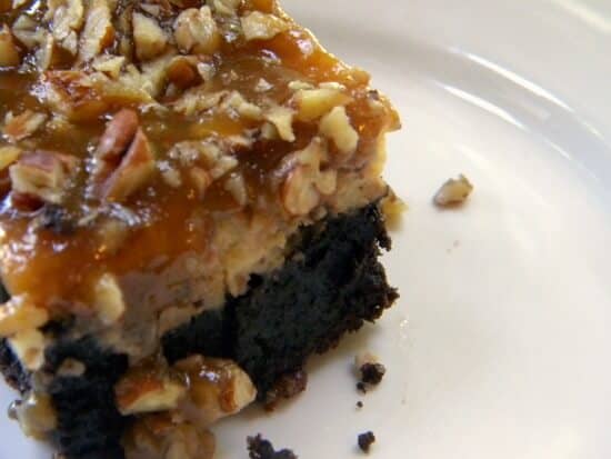 one praline cheesecake brownie. a rich brownie is covered with cheesecake then topped with pecan praline. Recipe image