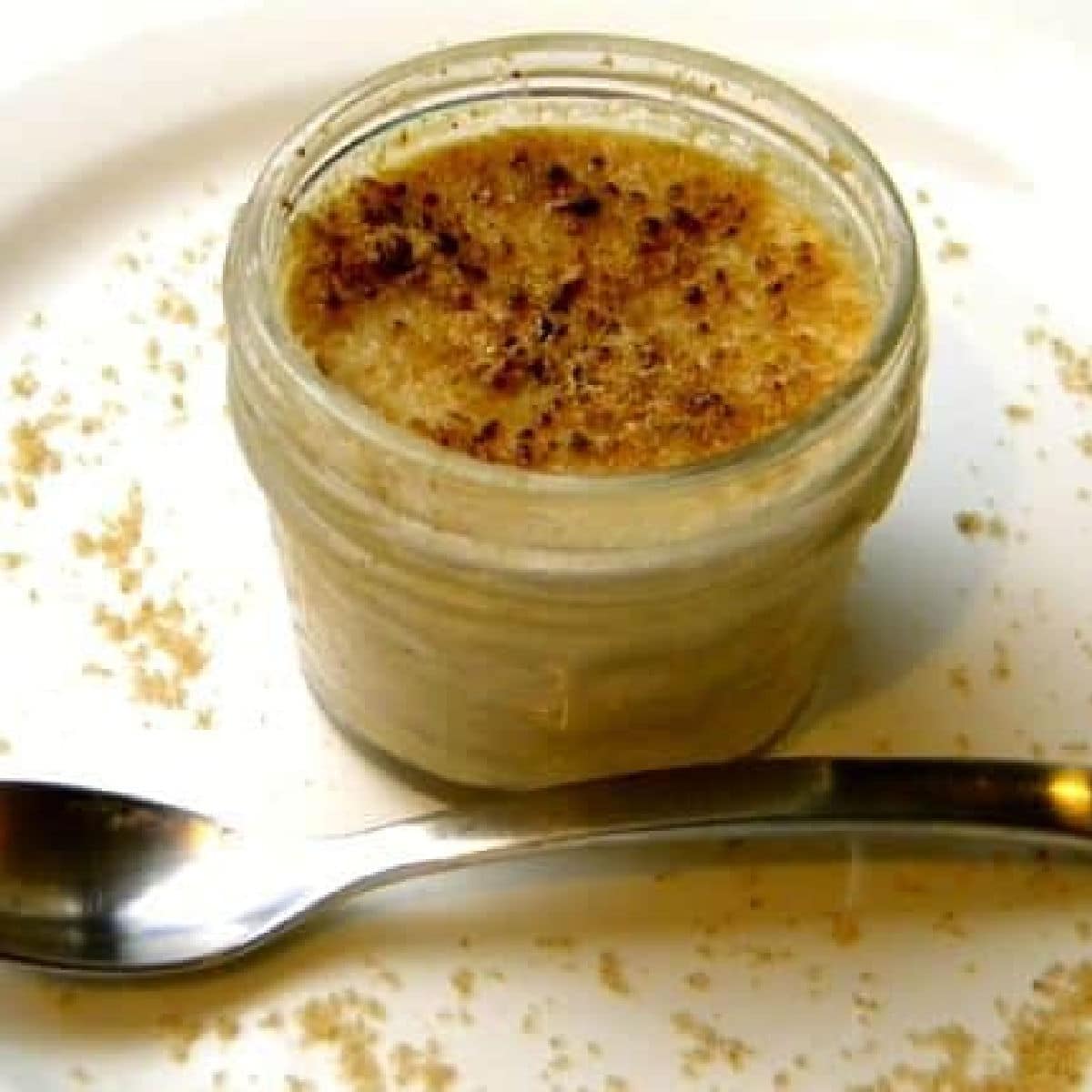 A small jar of peanut butter pots de cream on a plate.