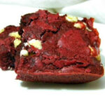 A stack of red velvet brownie squares with white chocolate chips.