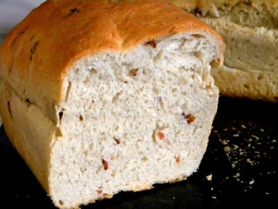 A loaf of bacon bread that has been sliced to show the inside.