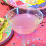 Pink punch in a stemmed glass.