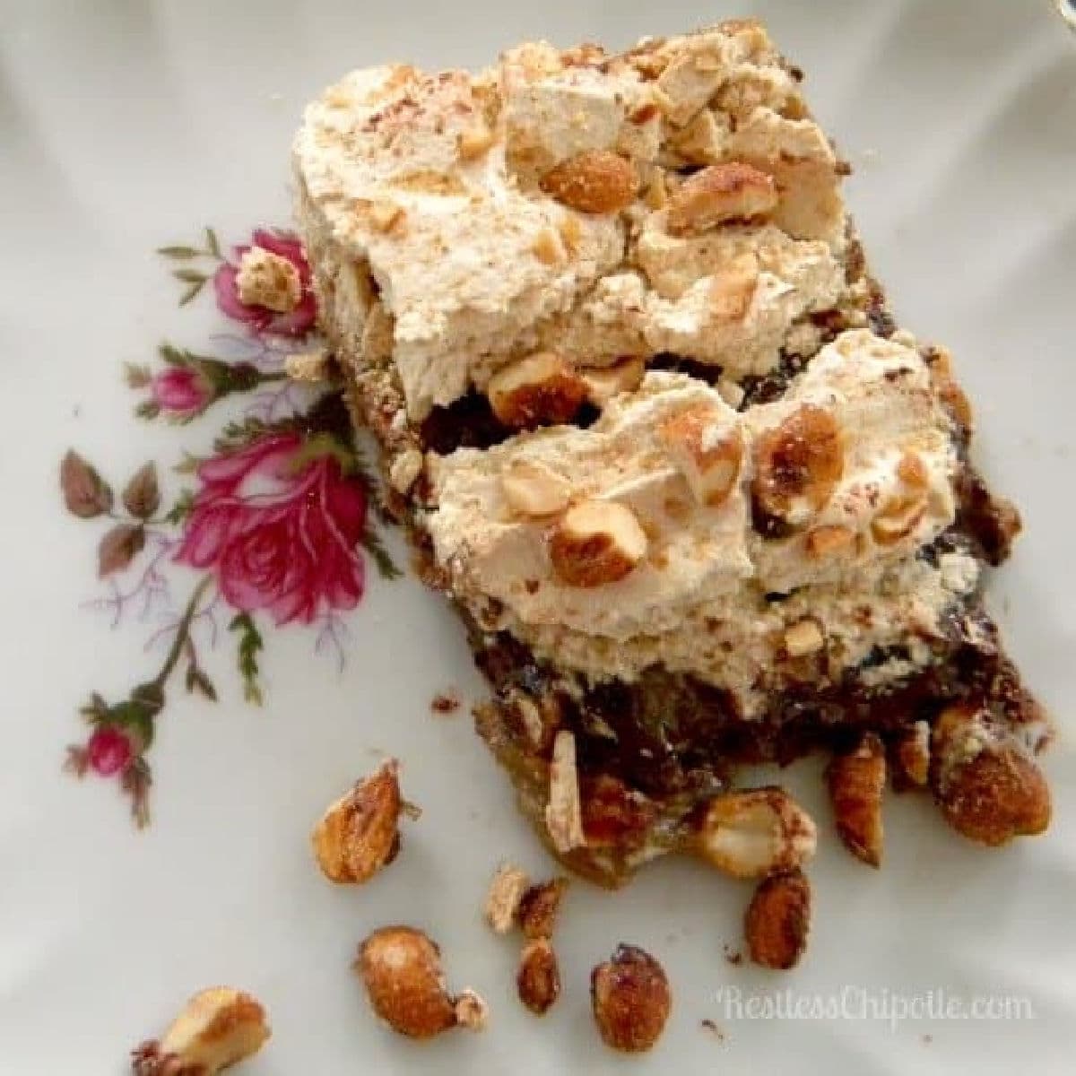 Bar cookies with a golden brown meringue topping on a plate.