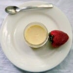 Overhead view of creme caramel with a strawberry.