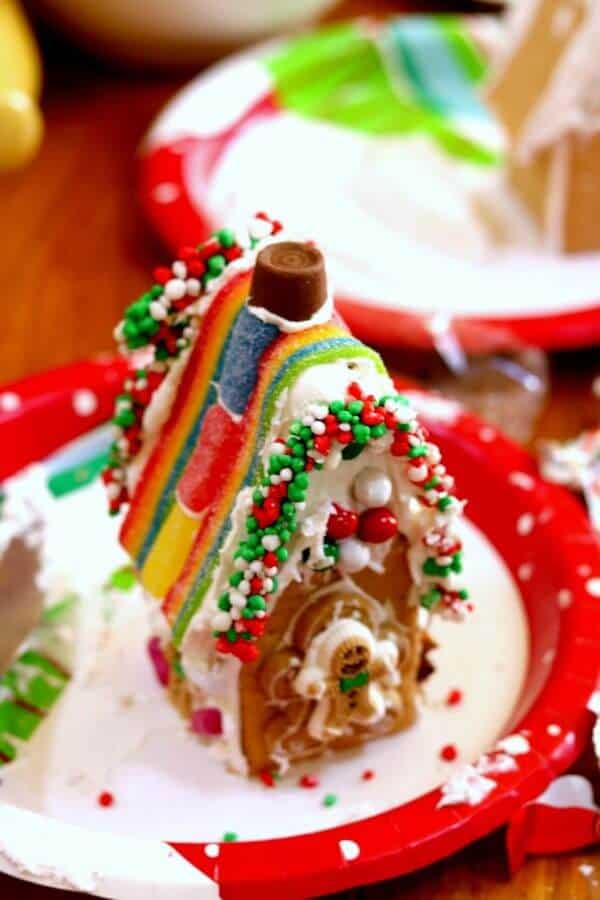 A gingerbread house from graham crackers has been decorated with colorful candy and is waiting to be judged...or eaten.