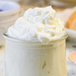 A side view of a jar of mock Devonshire cream with text overlay for Pinterest.