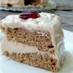 Slice of spice cake with maple cream cheese butter cream between the layers