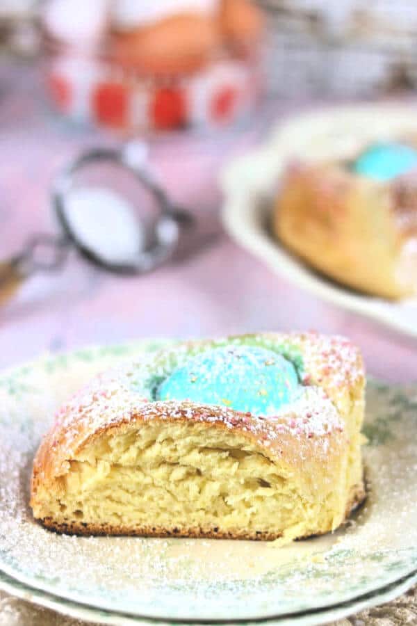 A square serving of Italian Easter egg bread on a vintage plate.