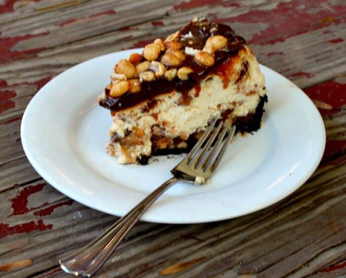 Homemade Snickers Bar Cheesecake with chocolate, caramel, and peanuts.|restlesschipotle.com