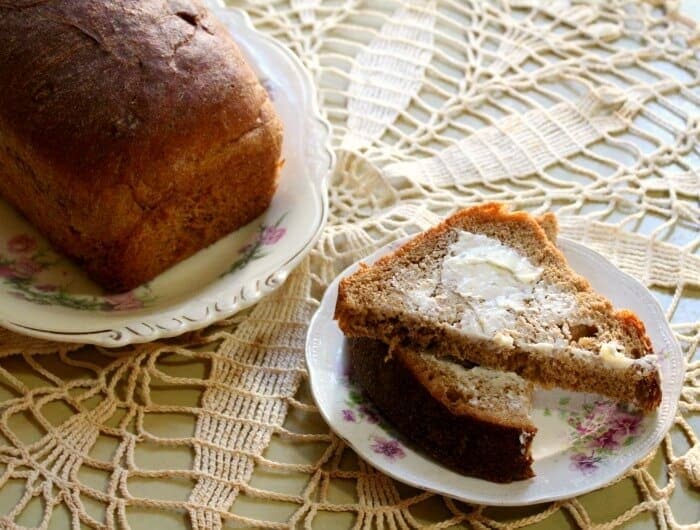 Slices of whole wheat bread with butter on them.