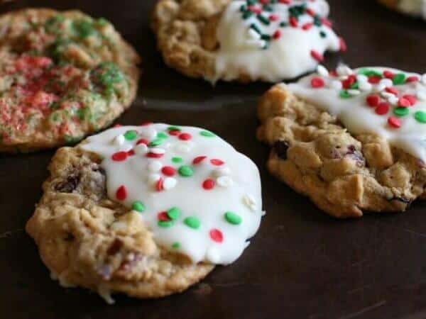 Four cranberry white chocolate oatmeal cookies dipped in white chocolate and sprinkled with red and green sprinkles