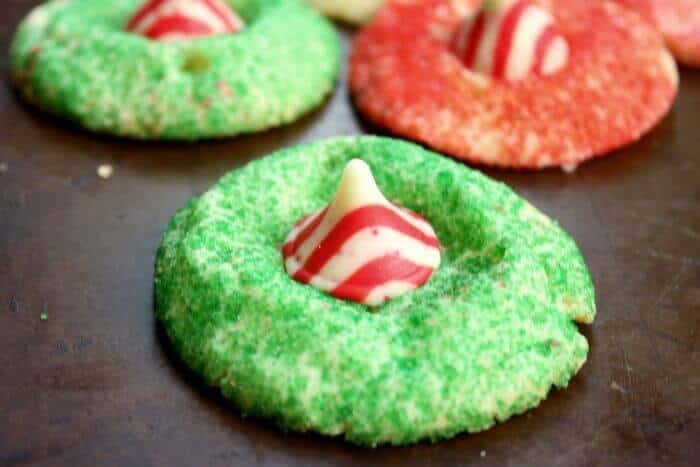 Red and green sugared cookies with a red and white chocolate peppermint kiss in the center