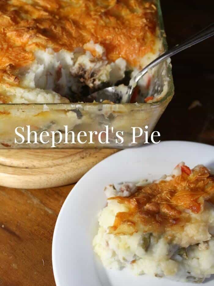 Shepherd's pie being served onto a white plate.