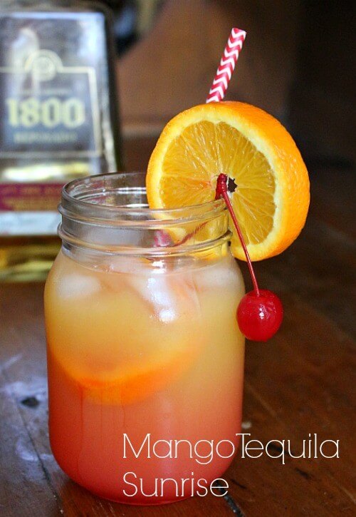 A quart jar with a pink and yellow cocktail in it.