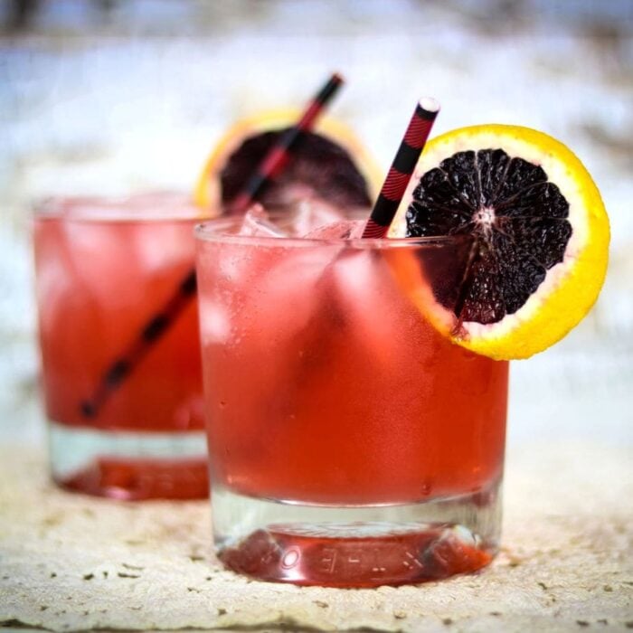 close up of red cocktails in short glasses.