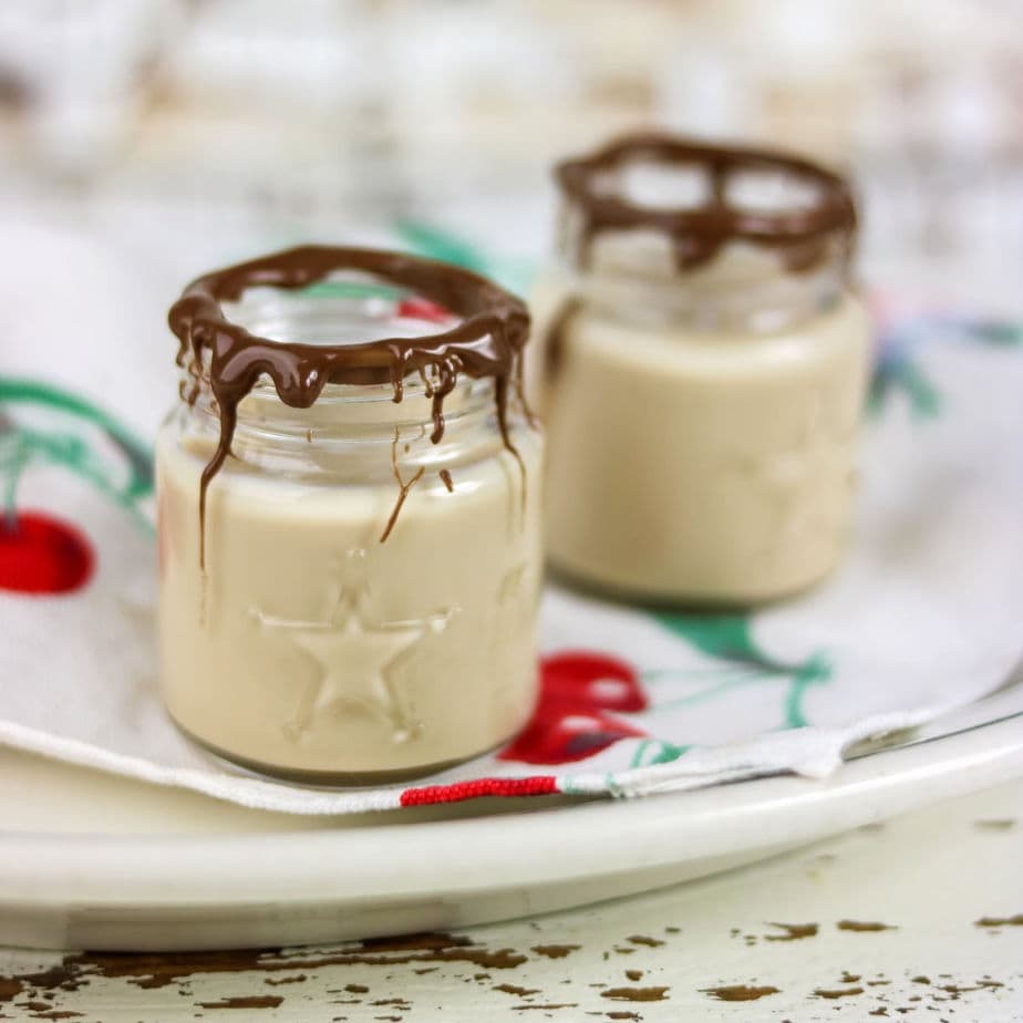 Closeup of two shot glasses with whiskey shots inside.