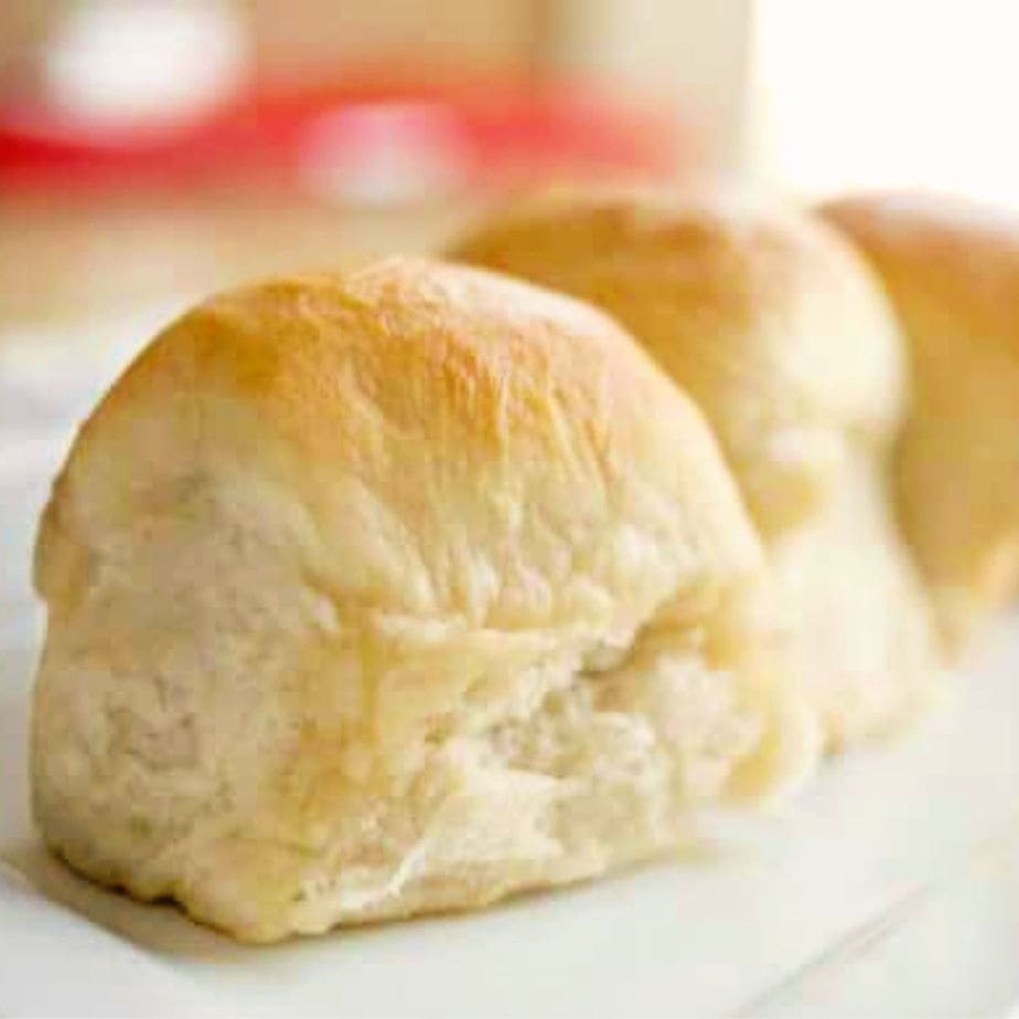 golden brown potato rolls on a plate for recipe card