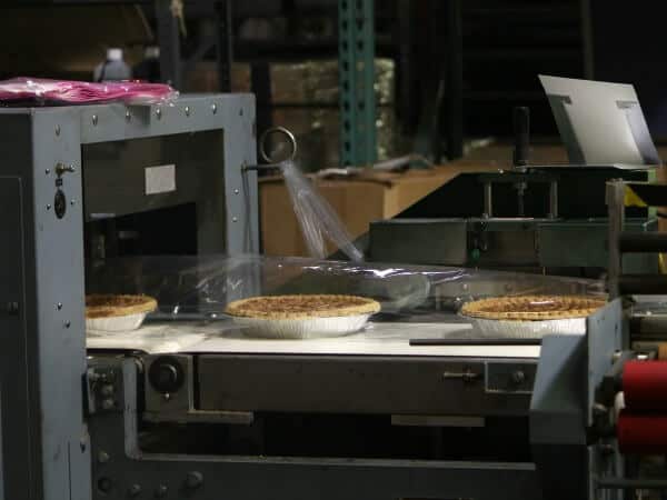 Collin Street Bakery in Corsicana Texas makes all kinds of baked goods. Here, pecan pies are wrapped for shipping and selling.. restlesschipotle.com