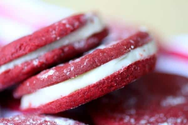 Creamy white chocolate and bourbon ganache fills these red velvet sandwich cookies from RestlessChipotle.com