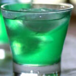 Bright green cocktail in a clear glass.