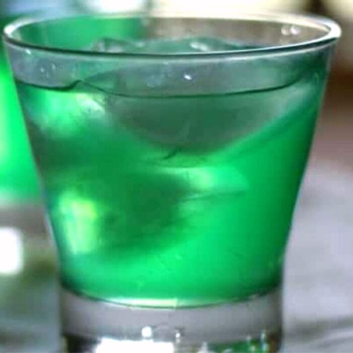 Bright green cocktail in a clear glass.