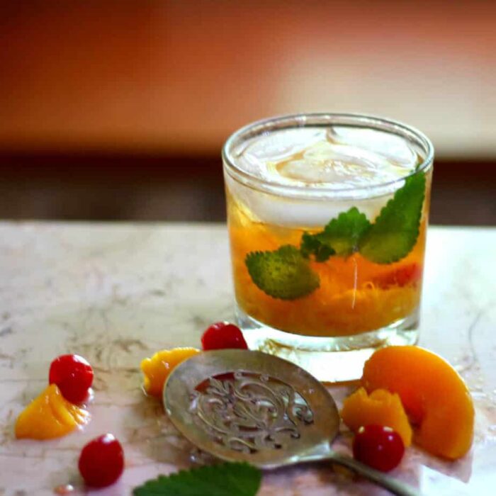 jacked up peach cocktail is easy to make and perfect for summer with peaches and jack daniels. from restlesschipotle.com