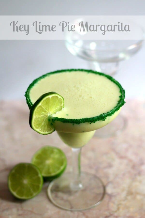 Key lime pie margarita in a margarita glass with a lime wheel garnish.