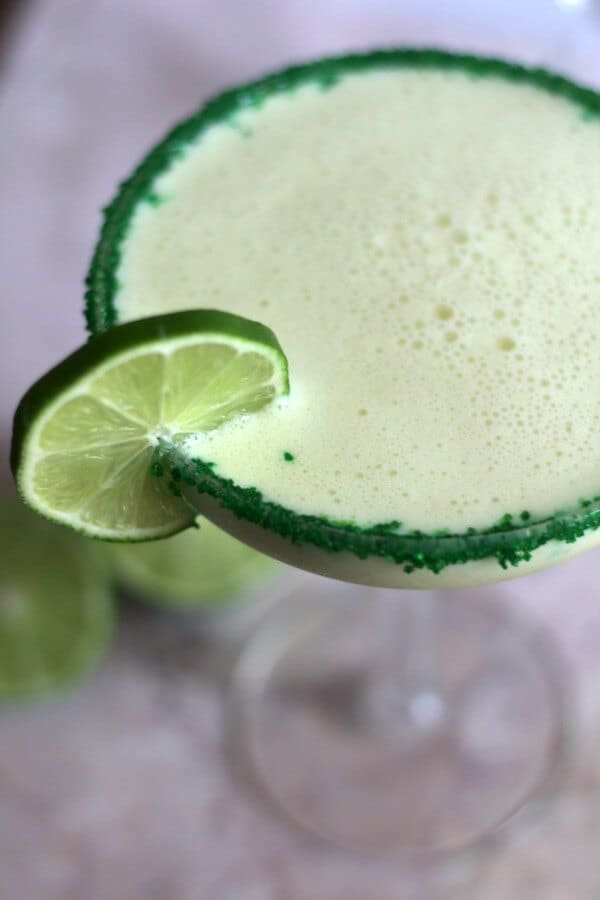 Closeup of the key lime pie margarita showing creamy bubbles on top.