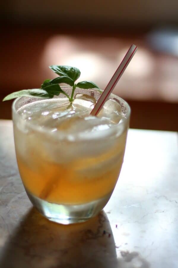 Closeup of a Texas mule cocktail with a fresh basil garnish.