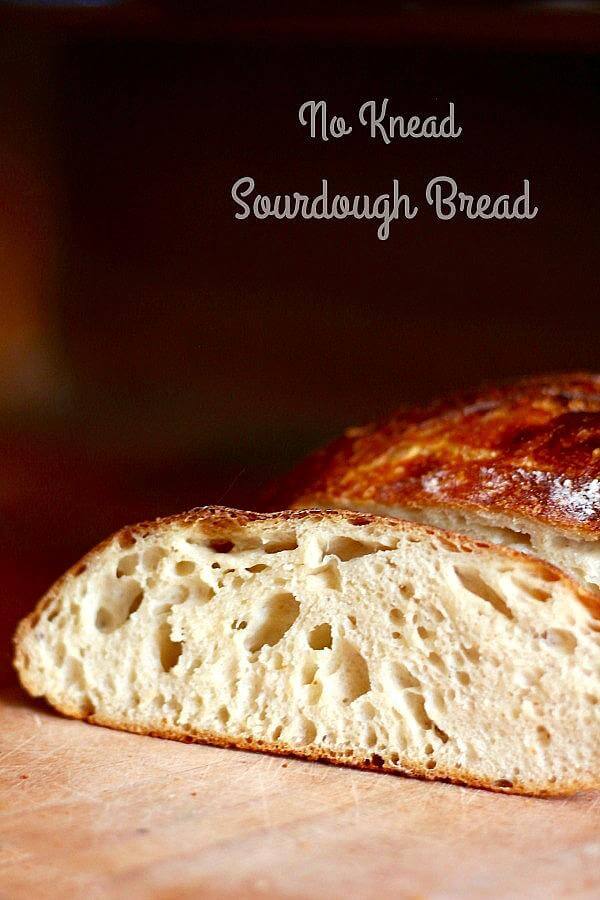 No knead sourdough bread sliced open to show the chewy texture.