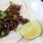 This slow cooked shredded beef is simmered in an updated red eye gravy. Delicious! From RestlessChipotle.com