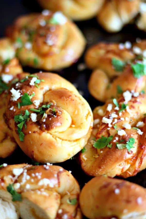 Easy Texas Knot Rolls are dipped in taco seasoned melted butter before serving. From RestlessCHipotle.com