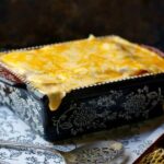 cheesy au gratin potatoes in a casserole dish - title text ovelay