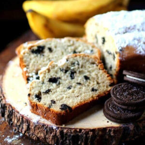 Slices of cookies and cream banana bread on a serving board.