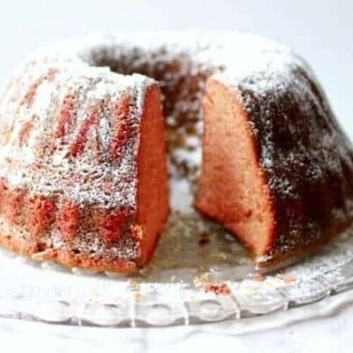 A cherry Dr Pepper bundt cake dusted with confectioner's sugar.