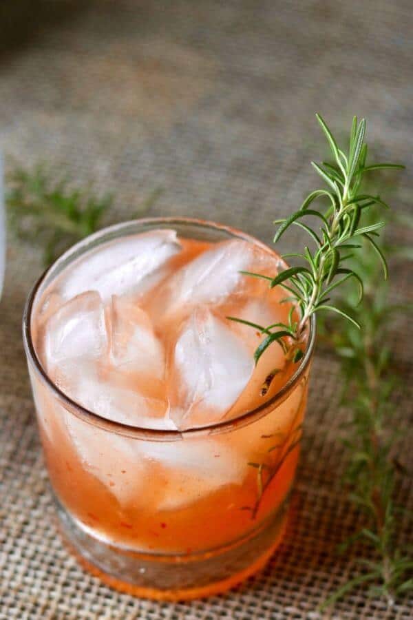 Overhead shot of a orange colored peach cocktail.